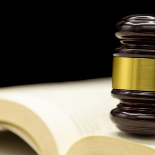 Judges gavel on book and wooden table. Law and justice concept background.